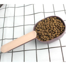 Compact pet food scoop with integrated bag clip for convenient storage.