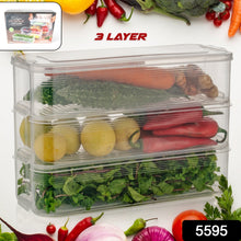 Stackable fridge storage containers holding fresh vegetables and fruits inside a refrigerator.