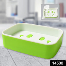 A green and white soap dish with a smiley face draining design, shown with a packaged version in the corner.
