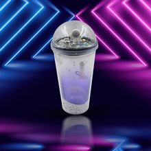 The double-wall plastic astronaut tumbler with its LED light on, displayed against a plain background.