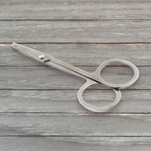 Elegant compact nail clipper set with its clear storage case for easy access.