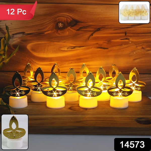 Twelve golden diya LED tealight candles with white bases glowing on a rustic wooden background, with a small box of four