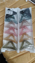 Colorful triangle shaped plastic hair claw clip styled in hair for a chic look