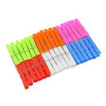 A neat arrangement of colorful plastic clothes clips, organized by color in rows, on a white background.