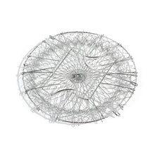The durable stainless steel chef basket straining boiled vegetables for a healthy meal.