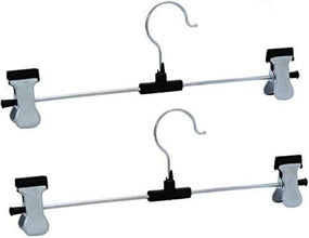 Organized wardrobe section showcasing clothes neatly hung on stainless steel hangers.
