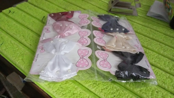 Packaging for the single multicolour hair bow clip.