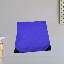 Close-up of the high-density fabric of the compact reusable shopping bag.