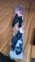 Neutral image showing product packaging with satin bow clips