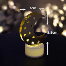 A single crescent moon LED tea light with warm yellow glow, showing dimensions of 7cm width and 5.5cm height.