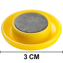 Collection of colorful circular board magnets on a flat surface.