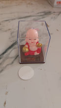 Solar Buddha Car Ornament in natural light, demonstrating its automatic head movement.