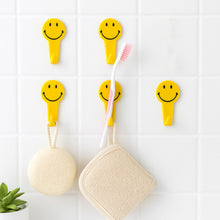 Waterproof self adhesive hooks holding towels in a modern bathroom.