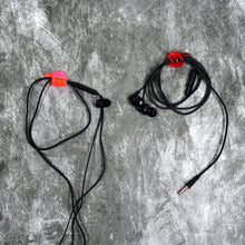 A set of multi-functional hand shape wall clips holding various items like cables and keys.