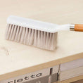 A durable household cleaning brush with a wooden handle, ideal for versatile dusting tasks.