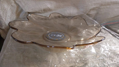 A side view of a flower shaped kids plastic plate, showing its shallow depth suitable for snacks and small meals.