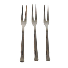 Three small appetizer forks laid out for serving snacks