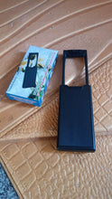 Extendable LED magnifier being used to read text clearly