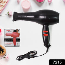 A black hair dryer with red buttons, a product box for a pink hair dryer, and various beauty items on a white surface.