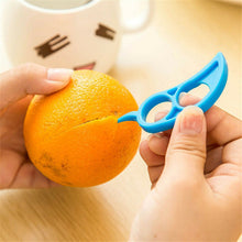 A bright orange being peeled with the Snail Orange Peeler, highlighting its mess-free capability.