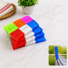 A stack of colorful plastic clothes clips in red, orange, green, blue, white, and pink, with a small inset of a blue clip on