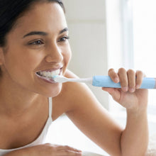 Adult using electric sonic toothbrush for effective dental hygiene