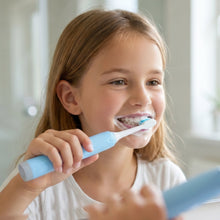 Child using electric sonic toothbrush for gentle cleaning