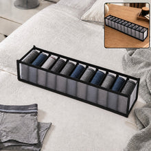 A gray 11-section fabric organizer filled with rolled socks sits on a white bedspread, with a smaller inset showing it on a