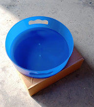 Revolving tray storage unit featuring a convenient brown box.