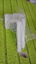 Detailed view of the strong, transparent adhesive hook used for mounting the storage rack without damaging walls.