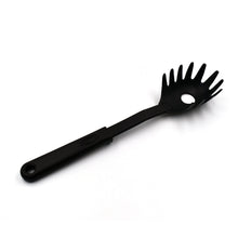 A black non-stick pasta server holding a generous portion of freshly cooked spaghetti.