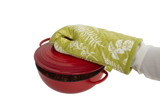 Hand holding a hot tray with the Heat Proof Oven Glove, demonstrating protection.