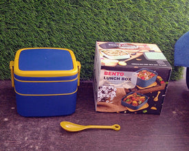 The complete blue portable bento lunch box with spoon and ergonomic carrying handle.