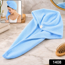 A light blue microfiber hair towel wrap with a button closure lies on a marble countertop, with a woman wearing one.