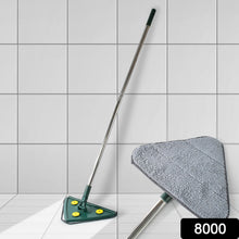 A green triangle mop with a silver handle stands against a white tiled wall, with a close-up of its gray microfiber head.