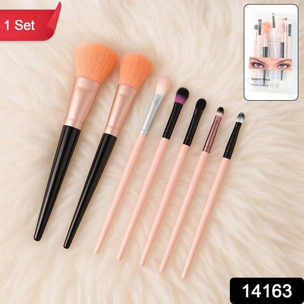 Seven makeup brushes with black and pink handles on a fluffy white surface, alongside a packaged set.
