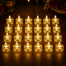 Twenty-four clear acrylic flameless LED tealight candles with warm yellow light arranged on a dark wooden surface.