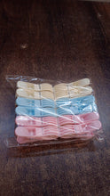 Colorful plastic cloth clips arranged neatly in rows for easy selection