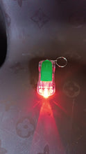 Person holding Mini Car LED Keychain Light to show compact size