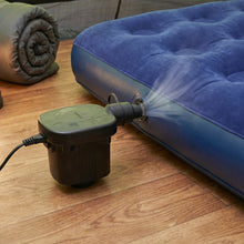 Electric air pump efficiently inflating a vibrant pool float for summer fun.
