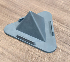 Grey pyramid mobile phone stand placed on office desk