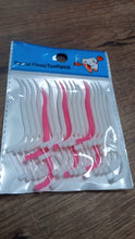 White dental floss picks with a textured grip.