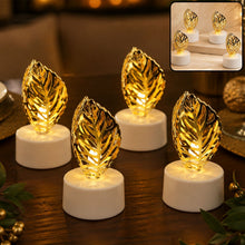 Four golden leaf LED candles illuminate a wooden table with blurred background decor.