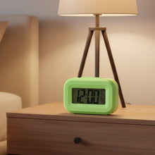 Close-up product image of digital alarm clock with date and temperature