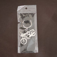 Lifestyle shot of a motorcycle silhouette metal keychain attached to a set of keys.