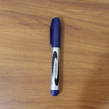 Marker pen writing with bold blue ink on smooth surface