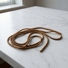 Durable brown spiral cable protector sleeve for keyboard and USB wires.