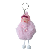 Hand holding plush doll keychain featuring soft fur ball accessory