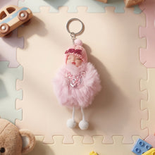 Plush doll keychain displayed on flat surface highlighting soft plush fabric