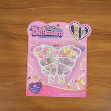 Creative kids using jewellery making kit to craft bracelets and necklaces